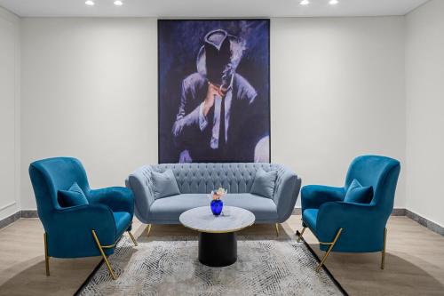 a living room with a couch and two chairs at Gewan Palace New Alamein in El Alamein