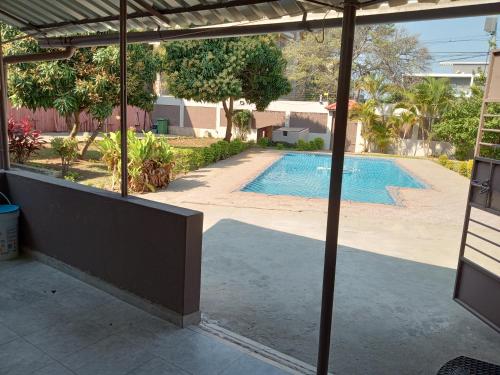a view of a swimming pool from the patio of a house at Sparkle Guest House - Self-Catering, Pool, Garden in Maputo