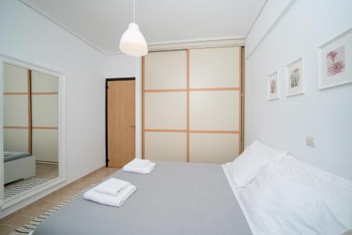 a bedroom with a bed and a mirror at Apollonian villa in Artemida