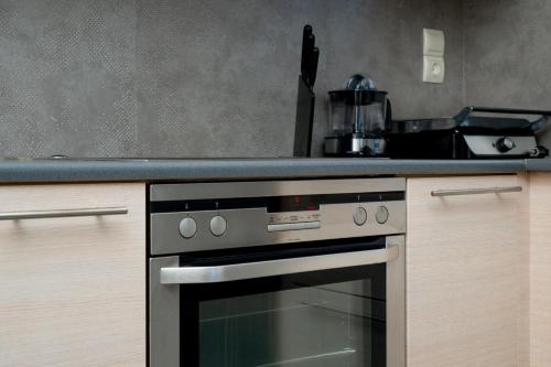 a kitchen with a stove and a counter top at Apollonian villa in Artemida