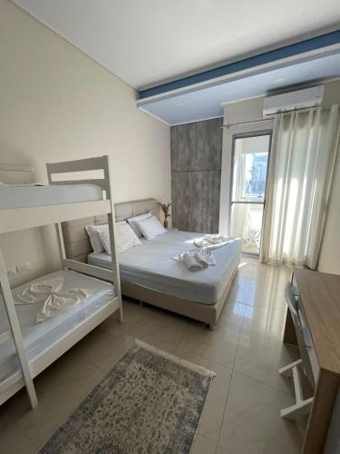 a bedroom with two bunk beds and a desk at FA_HOLIDAYS in Vlorë