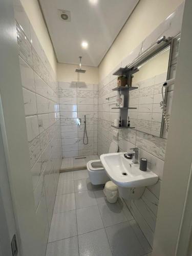 a bathroom with a sink and a toilet at FA_HOLIDAYS in Vlorë