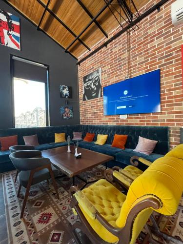 a living room with a couch and a table at Rozafa Fish City Hotel in Labinot i Poshtëm