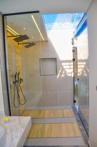 a shower with a glass door in a bathroom at Shams Prestige Abu Soma (Adults Only) in Hurghada