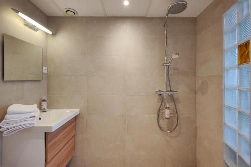 a bathroom with a shower and a sink at Aparthotel AMMI Nice Massena - ex Ajoupa in Nice
