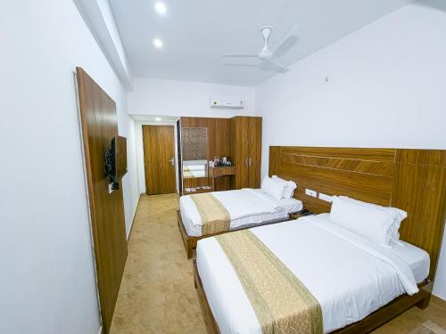 Ein Bett oder Betten in einem Zimmer der Unterkunft Amritara Ramila Kutir