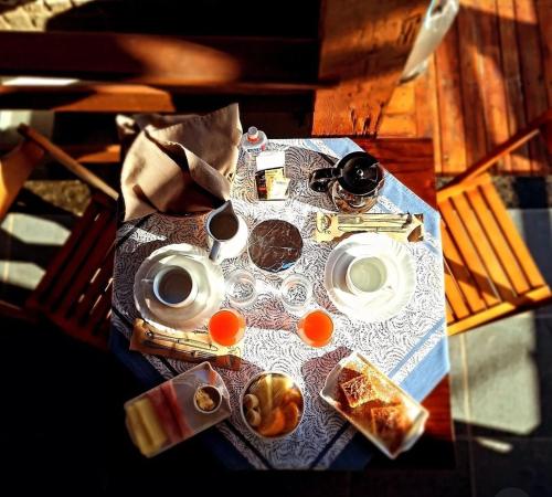 a table with breakfast foods and drinks on it at Casa Colomba in Búzios