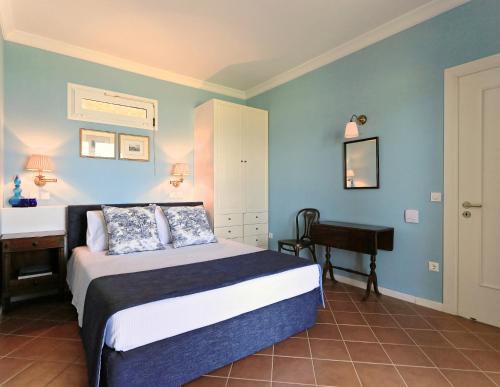 a bedroom with a bed and a desk and a piano at Villa Rhoe in Minia