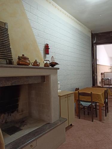 a living room with a fireplace and a dining room at Meraviglie Salentine in Lequile