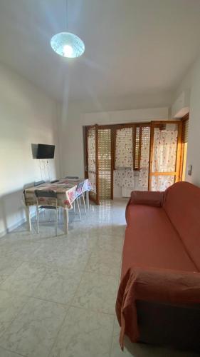 a living room with a couch and a table at A Casa Di Mina in Civitavecchia