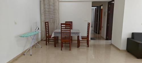 a dining room with a table and chairs at Rockfort stay inn in Oragadam