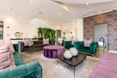 a living room with green furniture and purple furniture at MINT Hotel 84 on Katherine in Johannesburg