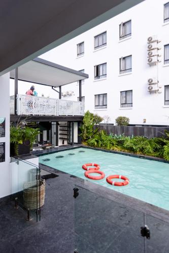 a swimming pool in front of a building at MINT Hotel 84 on Katherine in Johannesburg
