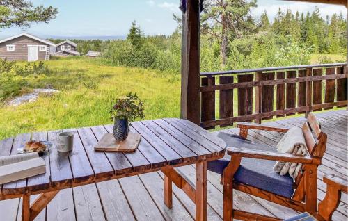 a wooden table and bench on a wooden deck at Gorgeous Home In Gol With Sauna in Sanderstølen