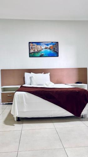 a bedroom with a large bed with at Hotel Mediterrâneo in Lagarto
