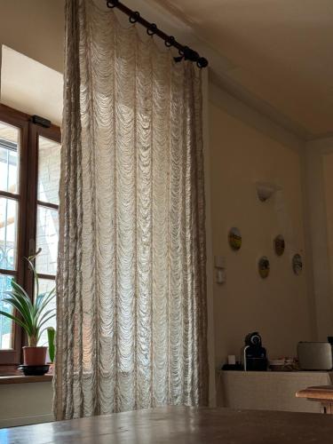 a curtain in a room next to a window at B&B Podere Cottimellino - Montalcino - Val d'Orcia in Montalcino