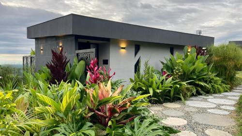 a small building in a garden with plants at La Font Ecolodge in Buenavista