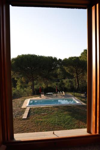 a view of a swimming pool through a window at Codirosso - Rustico in collina vicino al mare in Trebbiantico