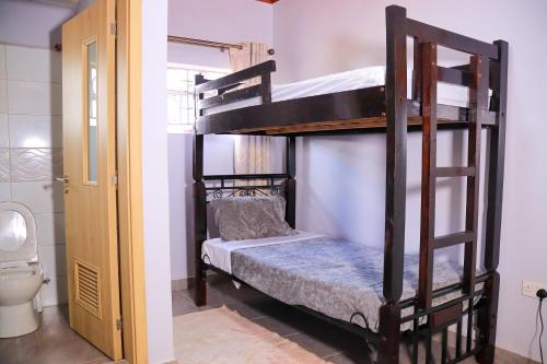 a couple of bunk beds in a room with a toilet at Garden Maskan Villa in Gicheru