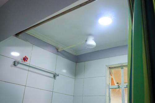 a bathroom with a shower curtain and a ceiling at Garden Maskan Villa in Gicheru