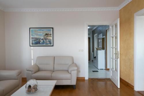 a living room with a couch and a table at Montesan Luxury Apartment Beach Front in Sveti Stefan
