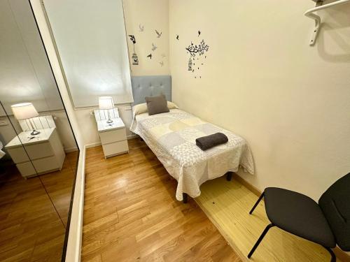 a small bedroom with a bed and two night stands at rooms Aragon in Barcelona