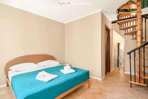 a bedroom with a blue bed with towels on it at La Perpetua, Terre Marine in Riomaggiore