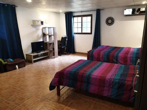 a room with two beds and a tv in it at A beachfront property very near to Panama city in Veracruz