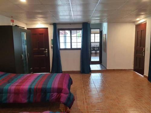 a room with a bed and a room with a window at A beachfront property very near to Panama city in Veracruz