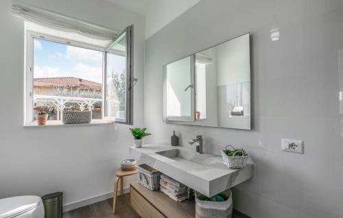 a white bathroom with a sink and a mirror at Stunning Home In Catenanuova in Centuripe