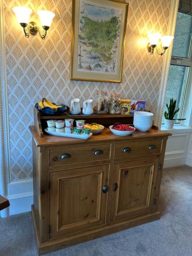 a large wooden cabinet with food on top of it at Glen Lyon Lodge Bed and Breakfast in Nairn