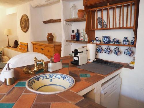 a kitchen with a counter with a sink and a counter top at Casa Real in Salar