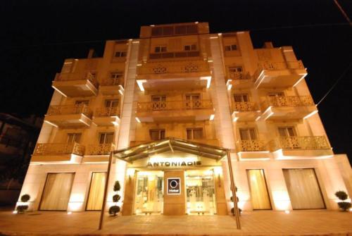 a large building with a store in front of it at Hotel Antoniadis in Kalabaka