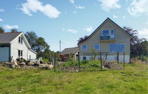 a house and a white house in a field at Amazing Home In Vikebygd With Wifi in Vikebygd