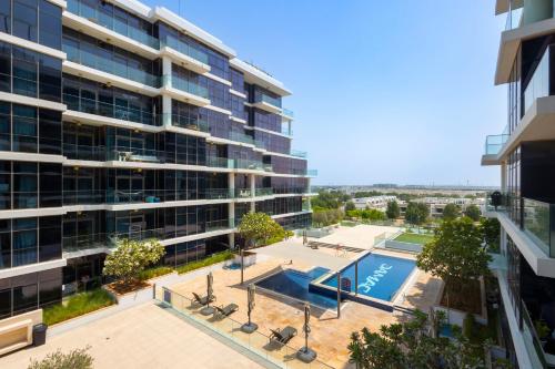 an overhead view of a building with a swimming pool at Serenity Living - stunning 1BR, DAMAC Hills in Dubai