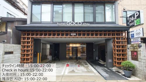 a building with a sign on the front of it at Hotel GOCO stay Kyoto Shijo Kawaramachi in Kyoto