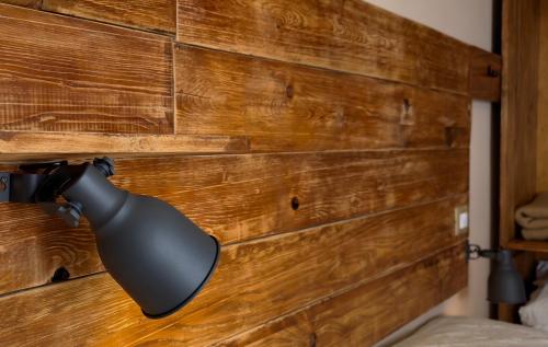 a black light on a wooden wall at B&B Selvaggio Blu in Baunei