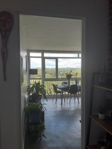 a living room with a table and a dining room at Appartement avec vue dégagée proche Paris in Boussy-Saint-Antoine