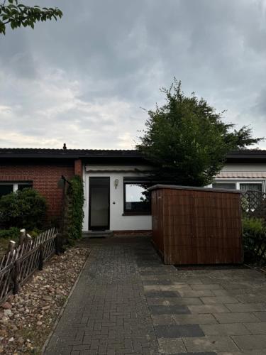 a house with a brick driveway in front of it at Villa Kunterbunt in Nienburg