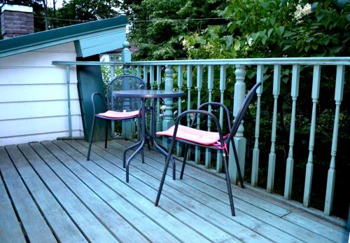 two chairs and a table on a deck at Guest House Krista in Jūrmala