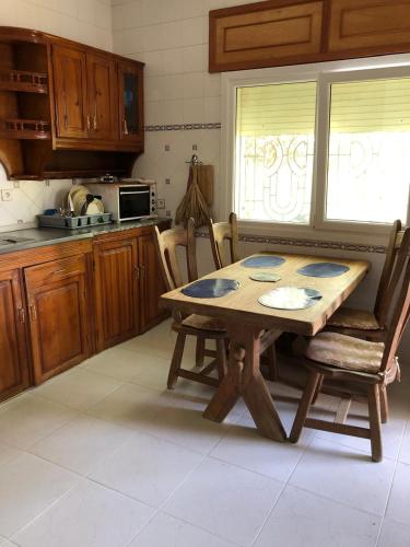 a kitchen with a wooden table and chairs in it at Cabo Air in Cabo Negro