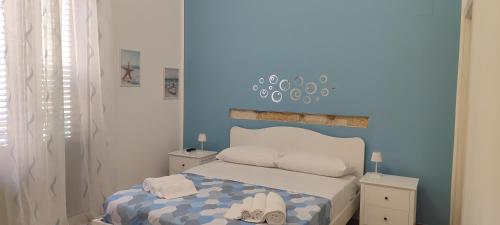 a bedroom with a bed with shoes on it at Balarm Central Apartment in Palermo