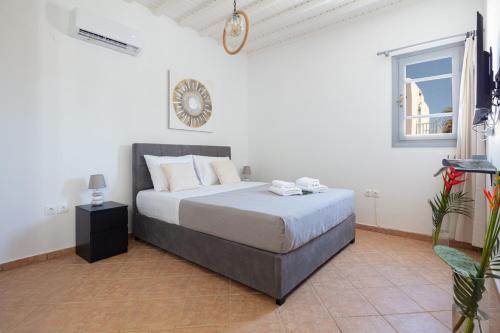a bedroom with a large bed in a white room at Aristeas Studio in Ornos