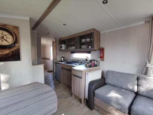a kitchen and living room with a couch and a table at Golden Sands beach activities sea holiday relax in Mablethorpe