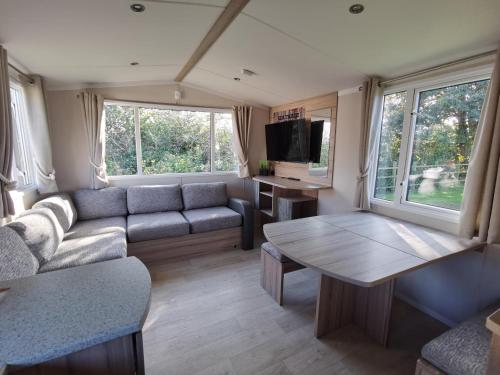 a living room with a couch and a table at Golden Sands beach activities sea holiday relax in Mablethorpe