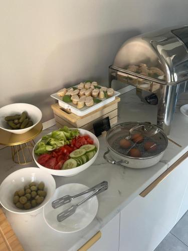 a kitchen counter with bowls of food on it at B&B Bloom Apartments in Vir