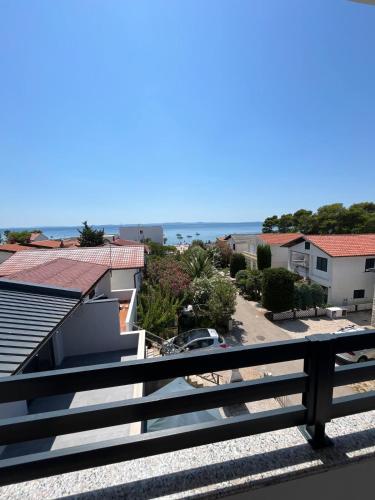 a view of the beach from the balcony of a house at B&B Bloom Apartments in Vir