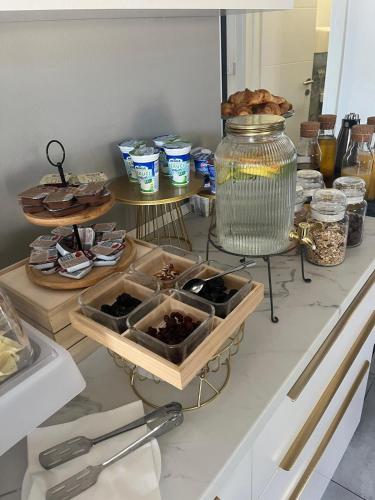 a kitchen counter with some plates of food on it at B&B Bloom Apartments in Vir