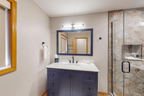 a bathroom with a sink and a shower at Bottle Bay View Lodge in Sagle
