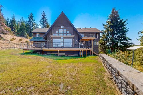 a large wooden house with a large yard at Bottle Bay View Lodge in Sagle